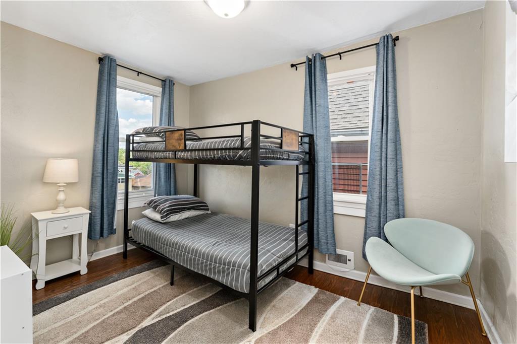 239 Albert Street Pittsburgh, PA 15211 - Photo 19 of 34 a bedroom with a bed and a chandelier