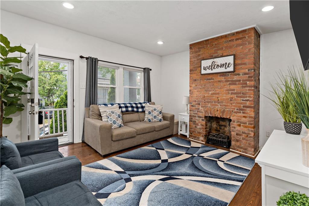 239 Albert Street Pittsburgh, PA 15211 - Photo 3 of 34 a living room with furniture and a fireplace