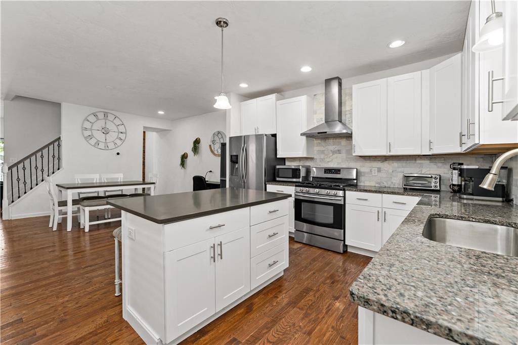 239 Albert Street Pittsburgh, PA 15211 - Photo 9 of 34 a kitchen with stainless steel appliances granite countertop a sink stove and refrigerator