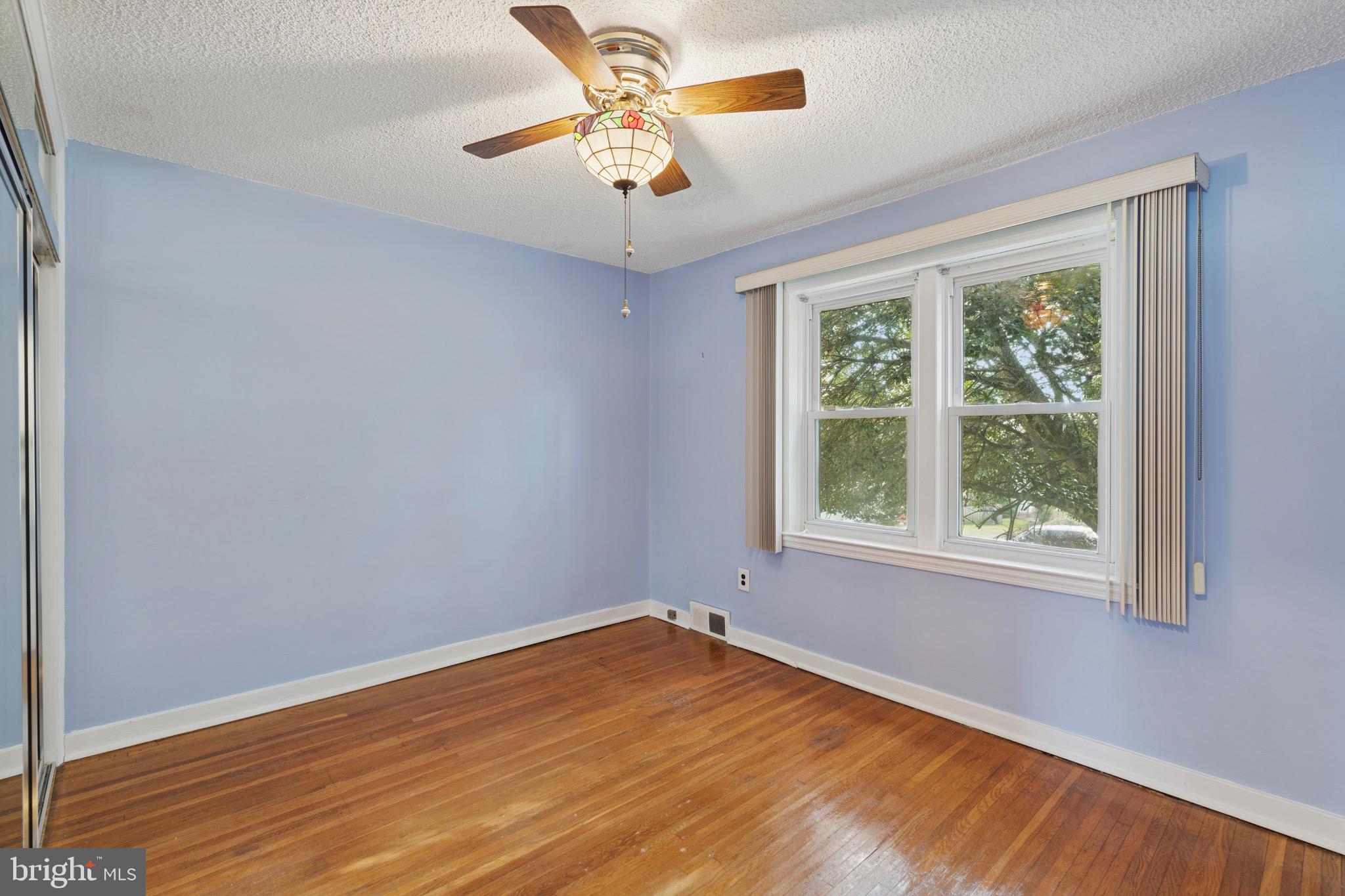 8613 Lykens Lane Philadelphia, PA 19128 - Photo 12 of 25 a view of empty room with wooden floor and fan