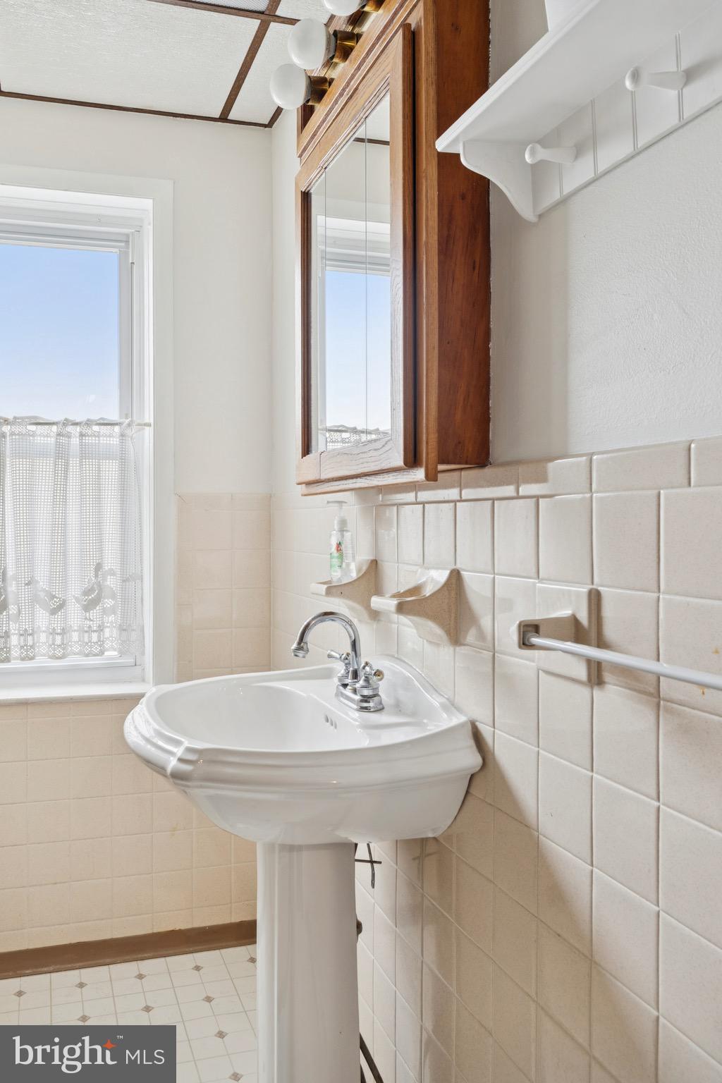 8613 Lykens Lane Philadelphia, PA 19128 - Photo 16 of 25 a bathroom with a sink and a mirror