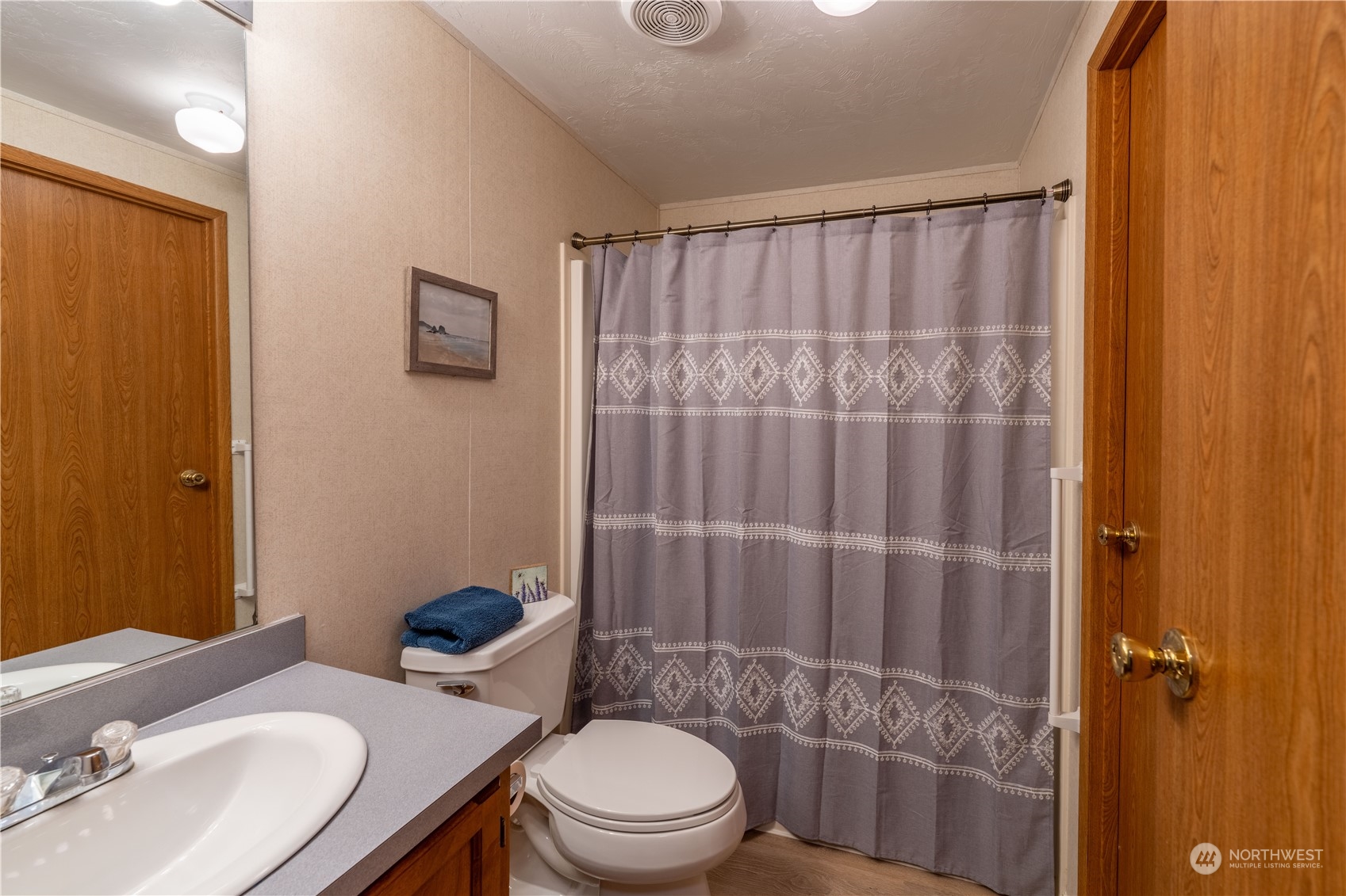 320 Fircrest Drive Sequim, WA 98382 - Photo 14 of 25 a bathroom with a sink a toilet and shower curtain