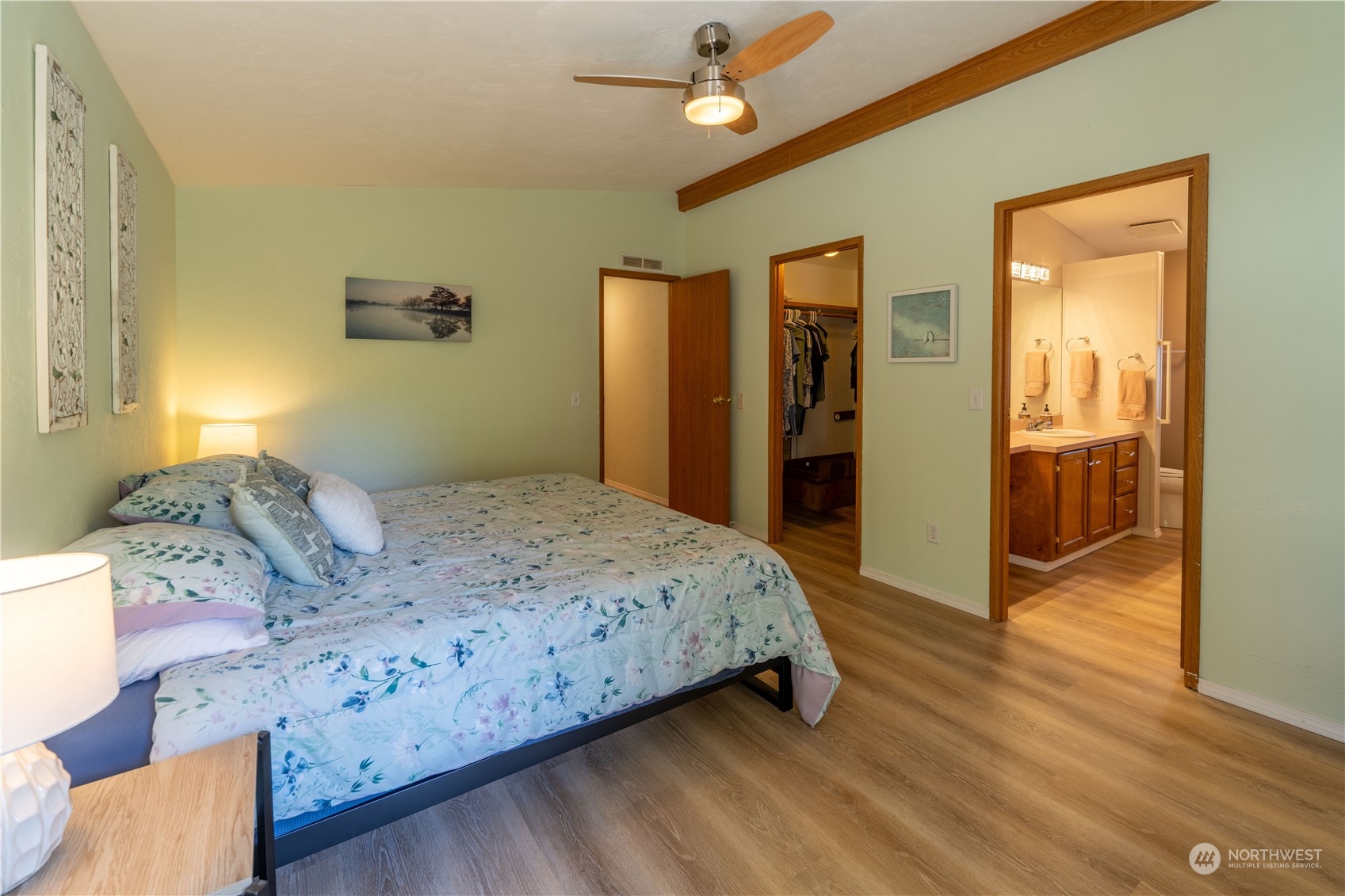 320 Fircrest Drive Sequim, WA 98382 - Photo 18 of 25 a bedroom with a large bed and a chandelier