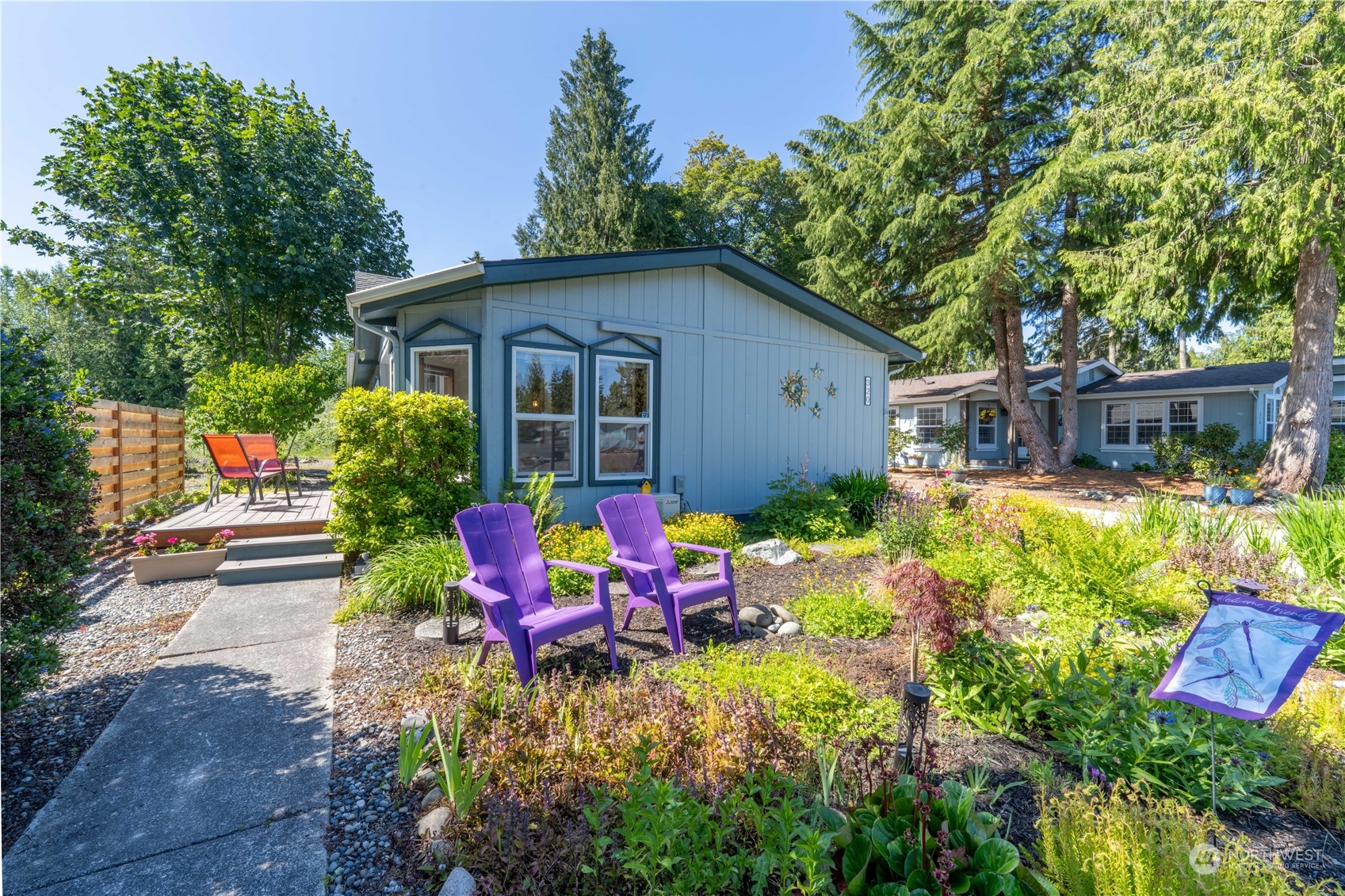 320 Fircrest Drive Sequim, WA 98382 - Photo 4 of 25 a backyard of a house with wooden table and chairs