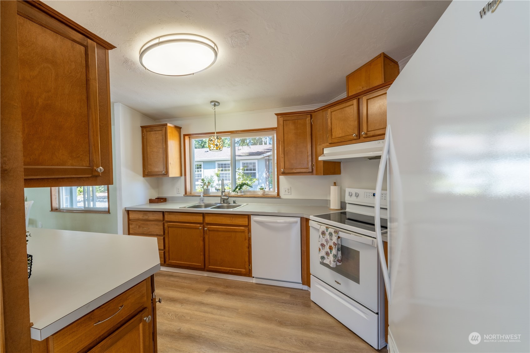 320 Fircrest Drive Sequim, WA 98382 - Photo 8 of 25 a kitchen with stainless steel appliances granite countertop a stove a sink and a refrigerator