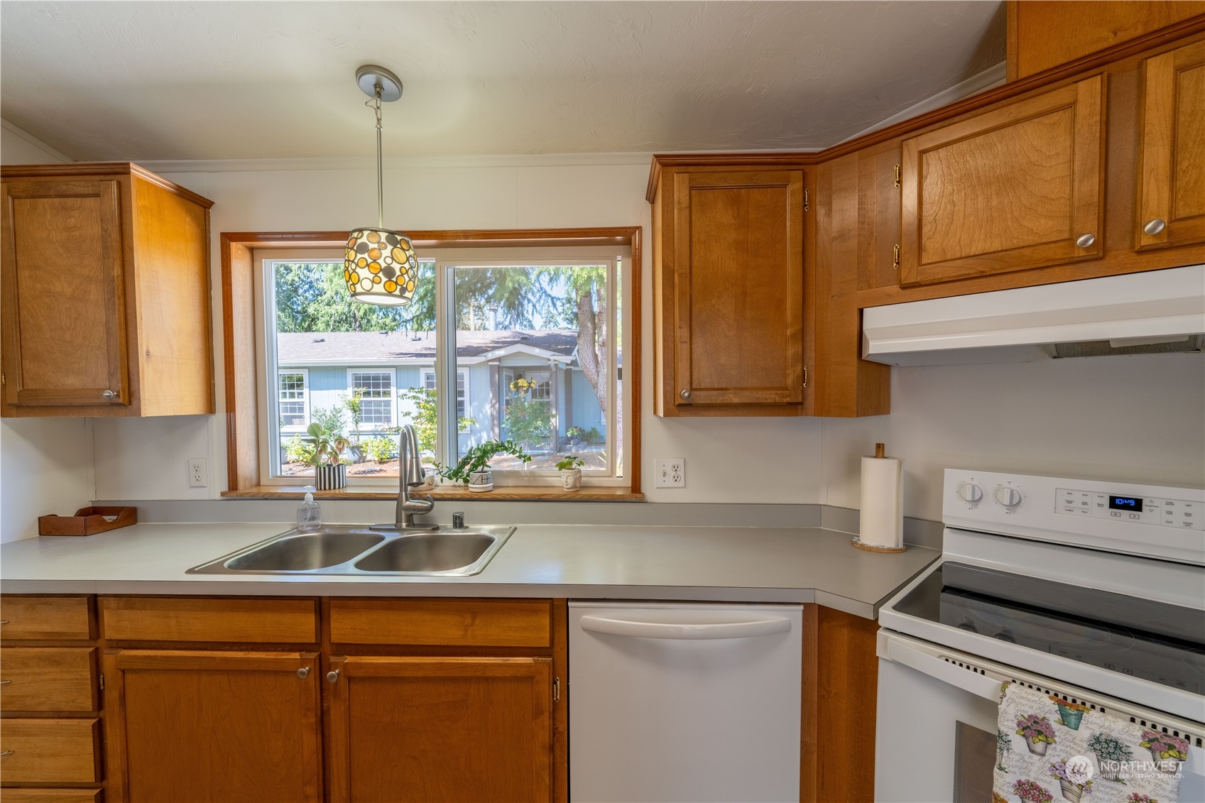 320 Fircrest Drive Sequim, WA 98382 - Photo 9 of 25 a kitchen with a sink and cabinets