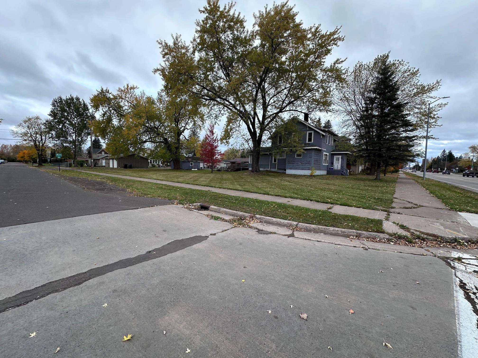 5634 Tower Avenue Superior, WI 54880 - Photo 6 of 7 View of asphalt street with sidewalks, a residential view, and curbs