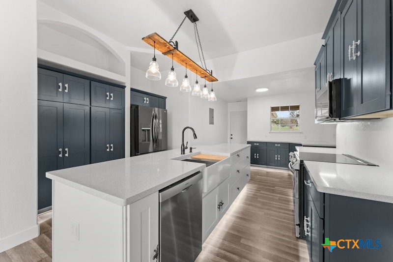 456 County Road 4711 Kempner, TX 76539 - Photo 12 of 31 a large kitchen with stainless steel appliances kitchen island granite countertop a sink and a refrigerator