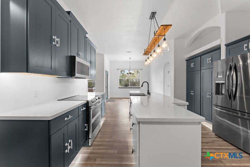 456 County Road 4711 Kempner, TX 76539 - Photo 13 of 31 a kitchen with stainless steel appliances granite countertop a sink a stove and a refrigerator
