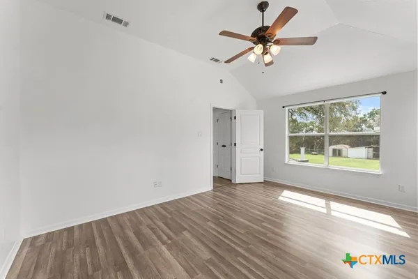 wooden floor in an empty room with a window