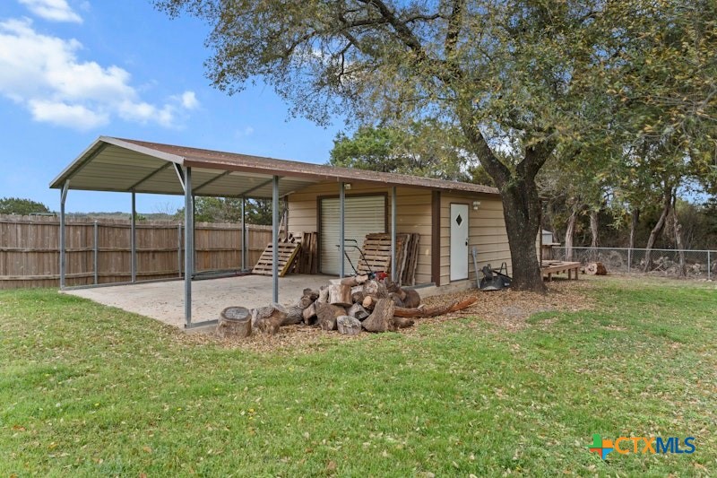456 County Road 4711 Kempner, TX 76539 - Photo 29 of 31 a view of a backyard with table and chairs under an umbrella