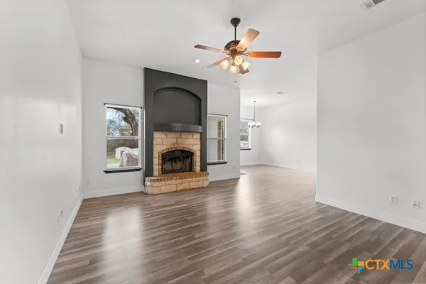a view of a livingroom with a fireplace and a chandelier
