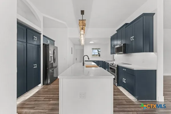 a kitchen with a sink and refrigerator