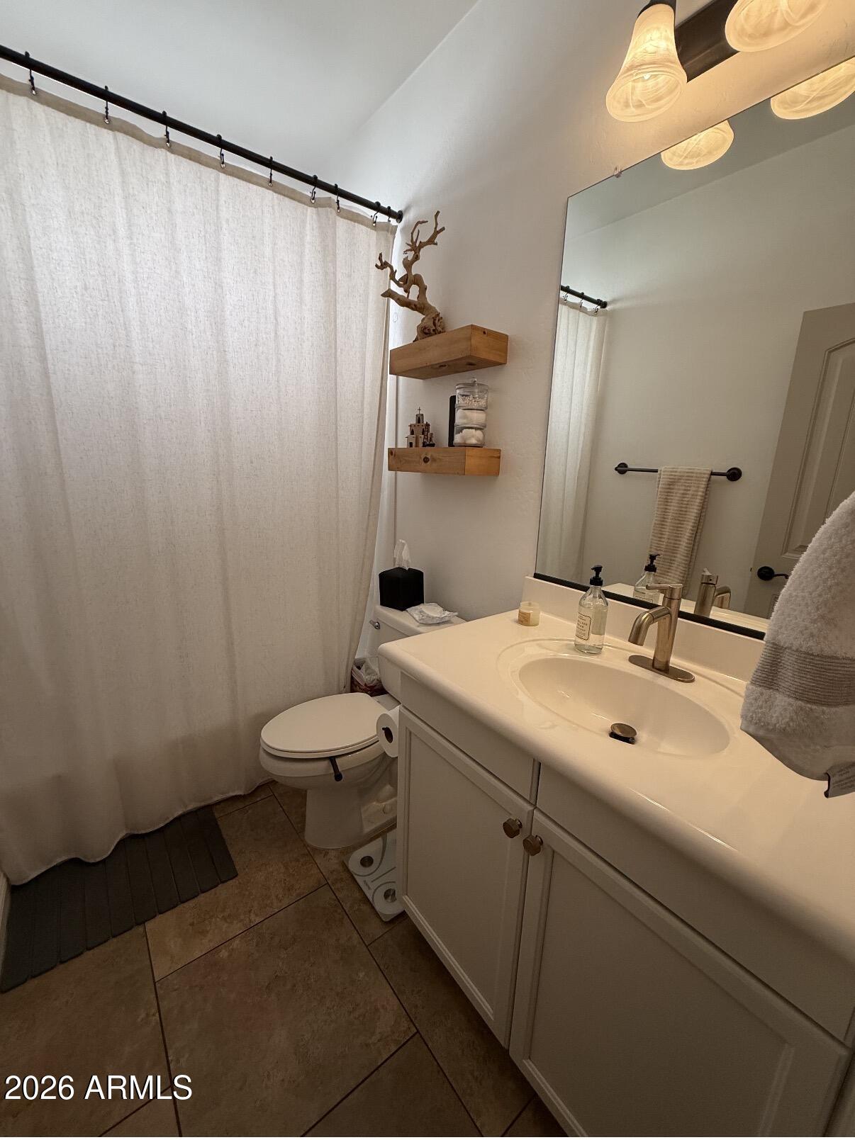 1377 South Chaparral Boulevard Gilbert, AZ 85296 - Photo 16 of 22 a bathroom with a sink and a mirror