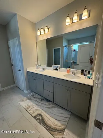 a bathroom with a double vanity sink and a mirror