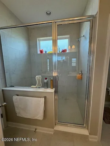 a bathroom with a shower and a sink
