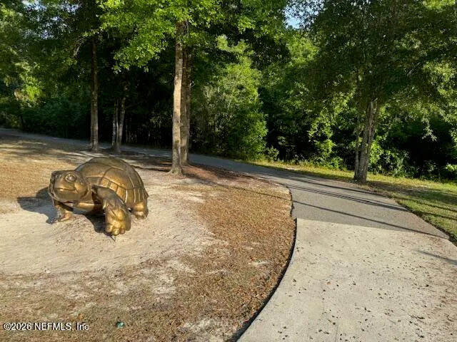 a view of a swimming pool with chairs and fire pit