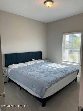 a bedroom with a bed and window