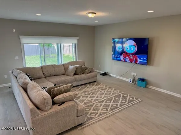 a living room with furniture a couch and a large window