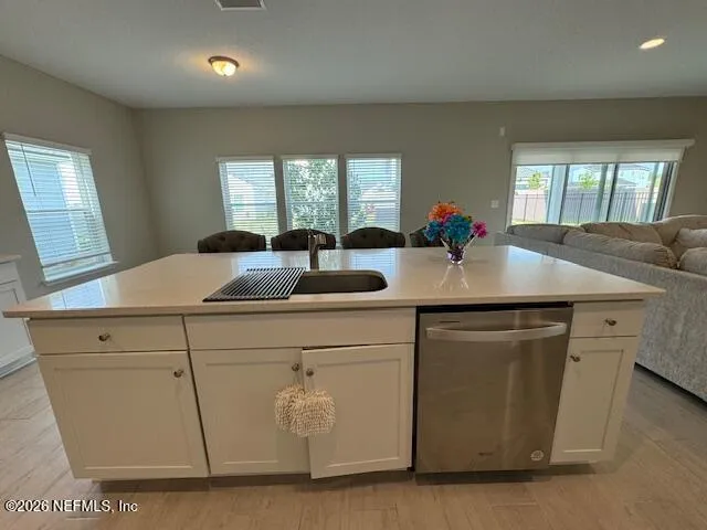 a kitchen with counter top space and windows
