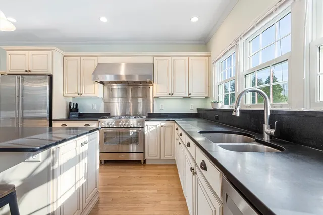 a kitchen with a sink stove and cabinets