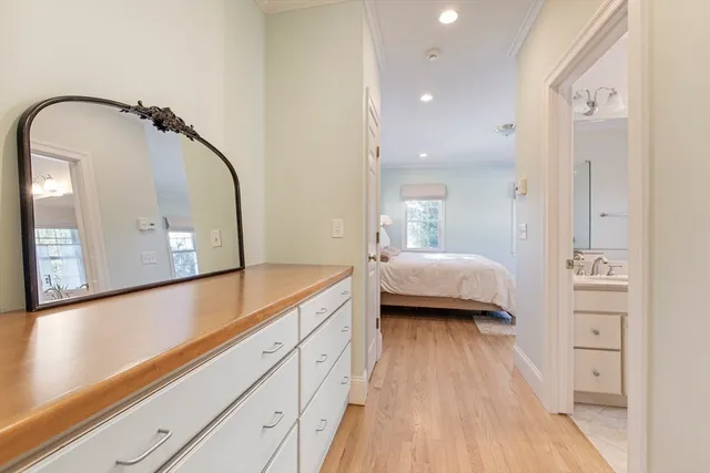 a en suite spacious bathroom with a granite countertop sink and a mirror