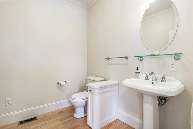 a bathroom with a sink a toilet and a mirror