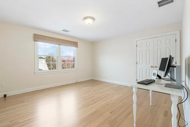 a view of a room with wooden floor