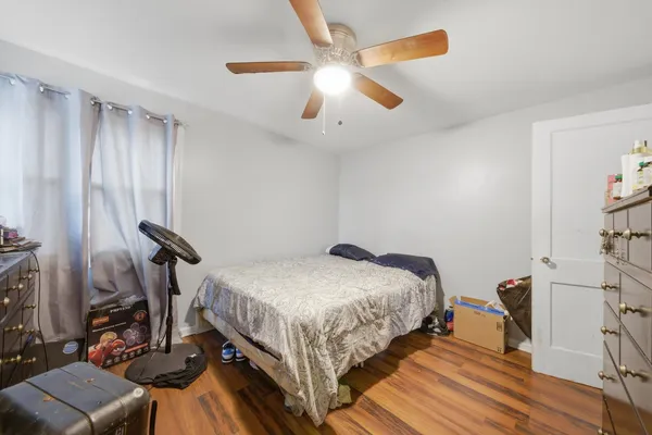 a bedroom with bed and a chandelier