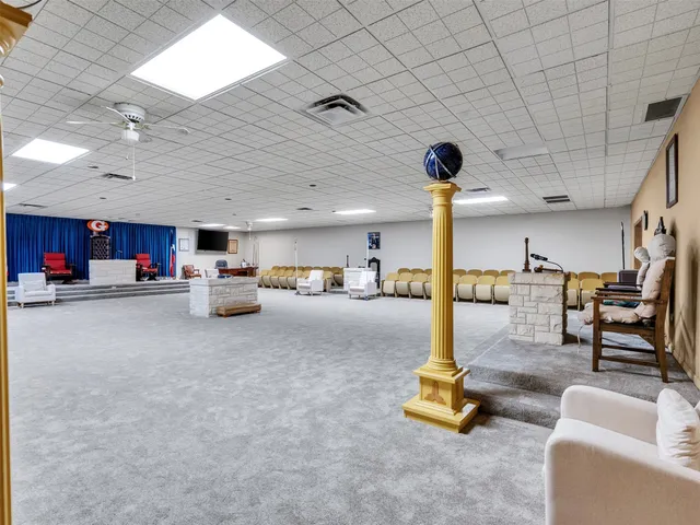 a living room with lots of furniture and kitchen view