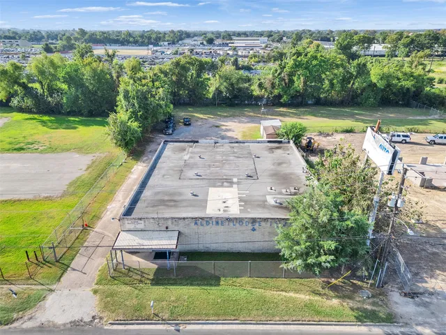 an aerial view of a house with a yard swimming pool and outdoor seating