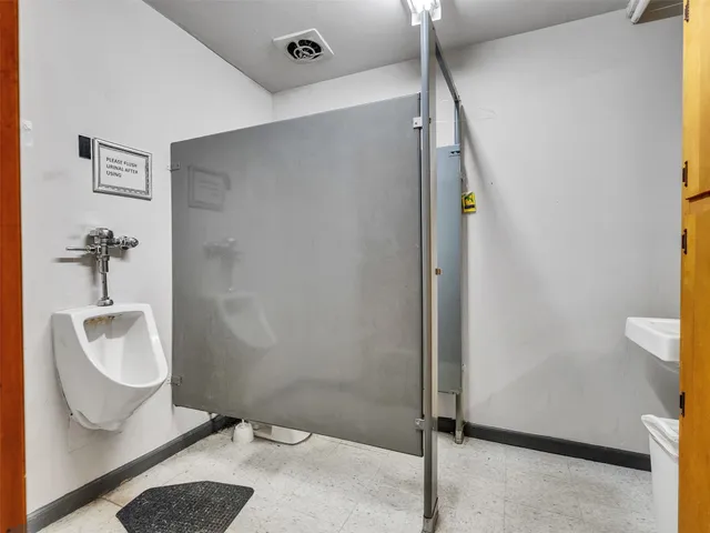 a bathroom with a toilet and a shower