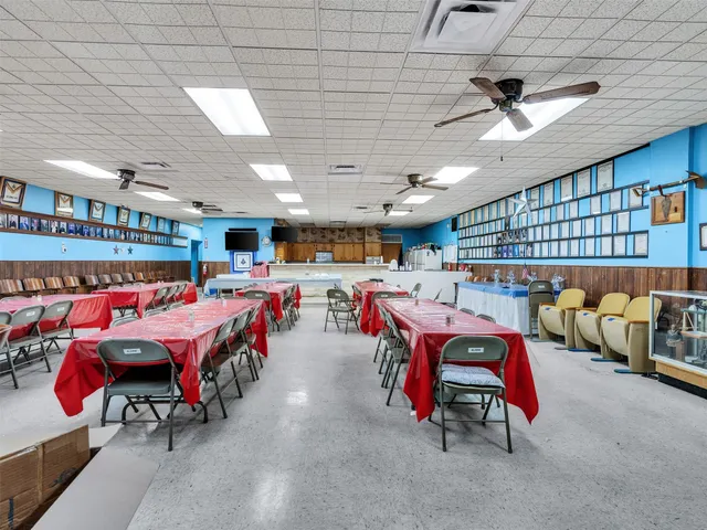 a living room with a table tennis pool table and chairs