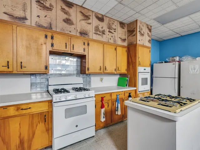 a kitchen with stainless steel appliances a stove a sink and a refrigerator