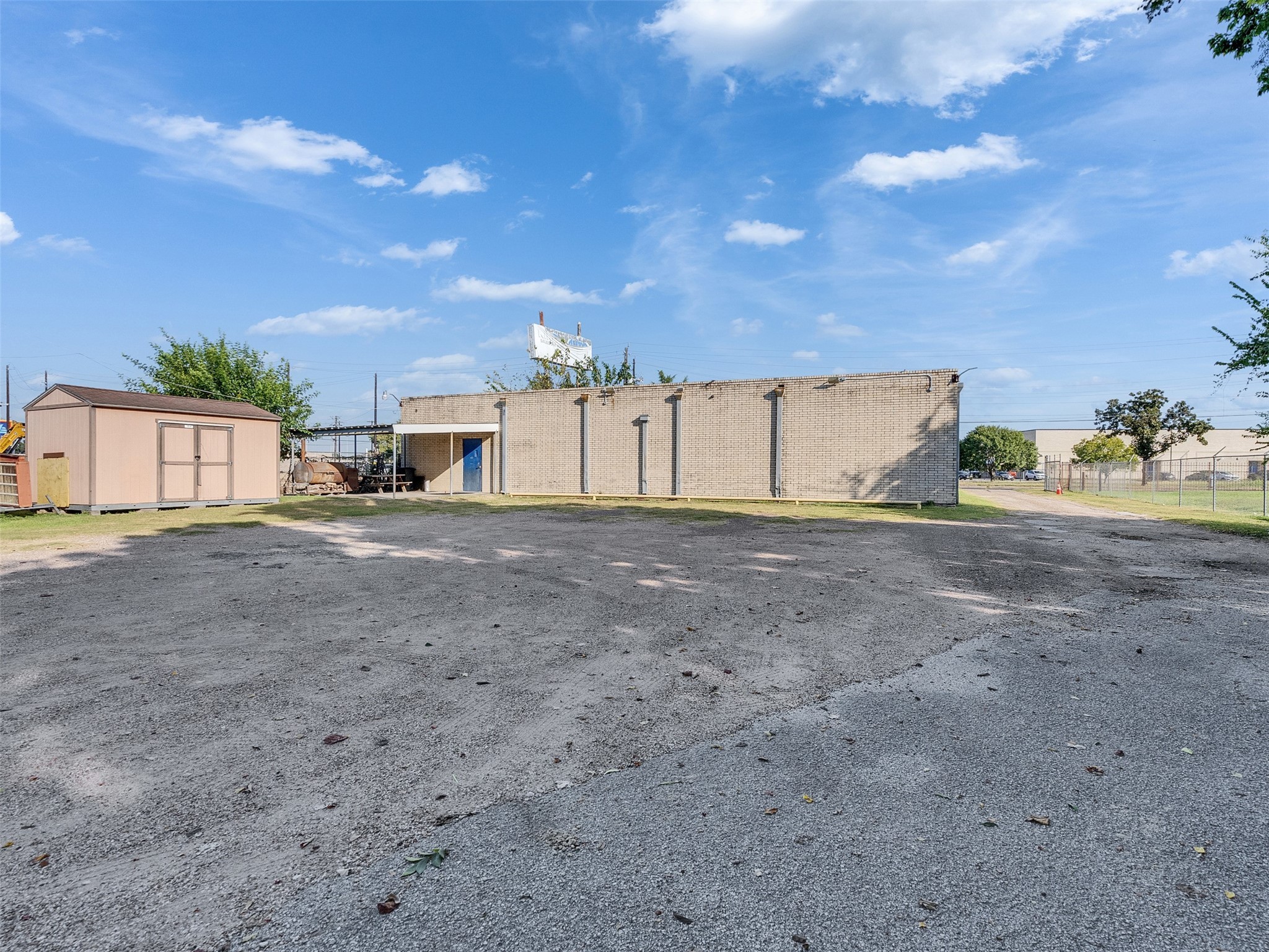 151 West Road Houston, TX 77037 - Photo 32 of 35 Backview of building from inside the lot. Blue door seen is a back entrance with covered area to building.