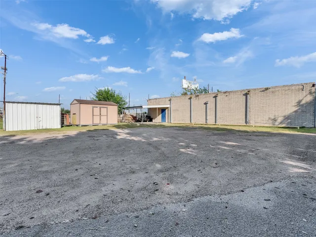a view of a house with a big yard and large tree