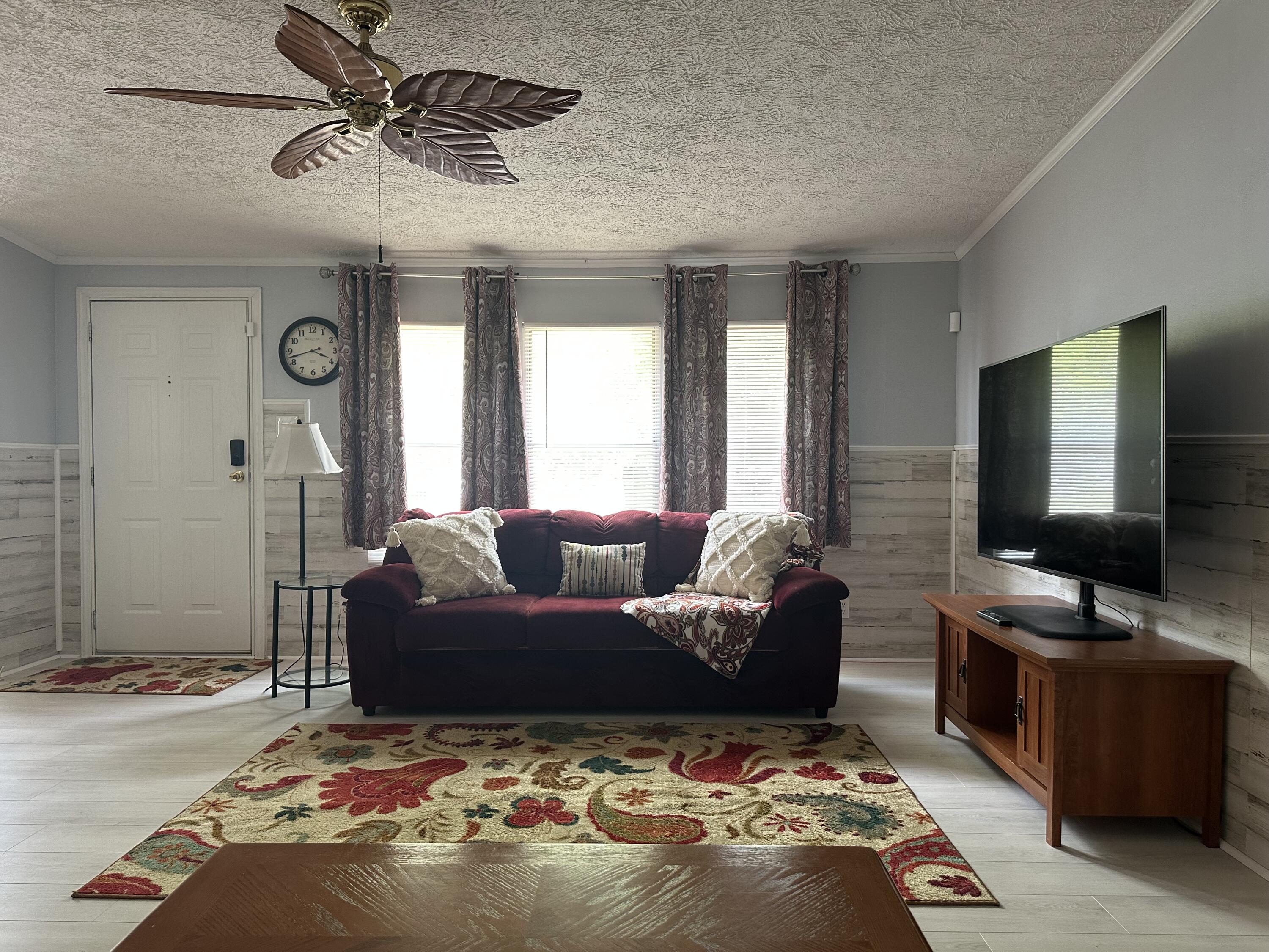 1510 Southwest 35th Circle Okeechobee, FL 34974 - Photo 18 of 53 a living room with furniture and a flat screen tv