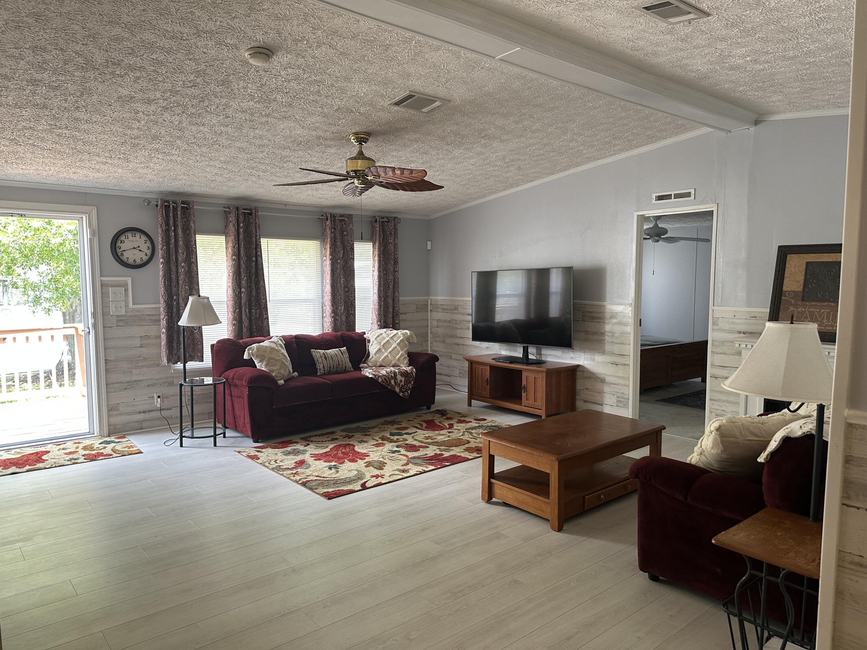 1510 Southwest 35th Circle Okeechobee, FL 34974 - Photo 19 of 53 a living room with furniture and a flat screen tv