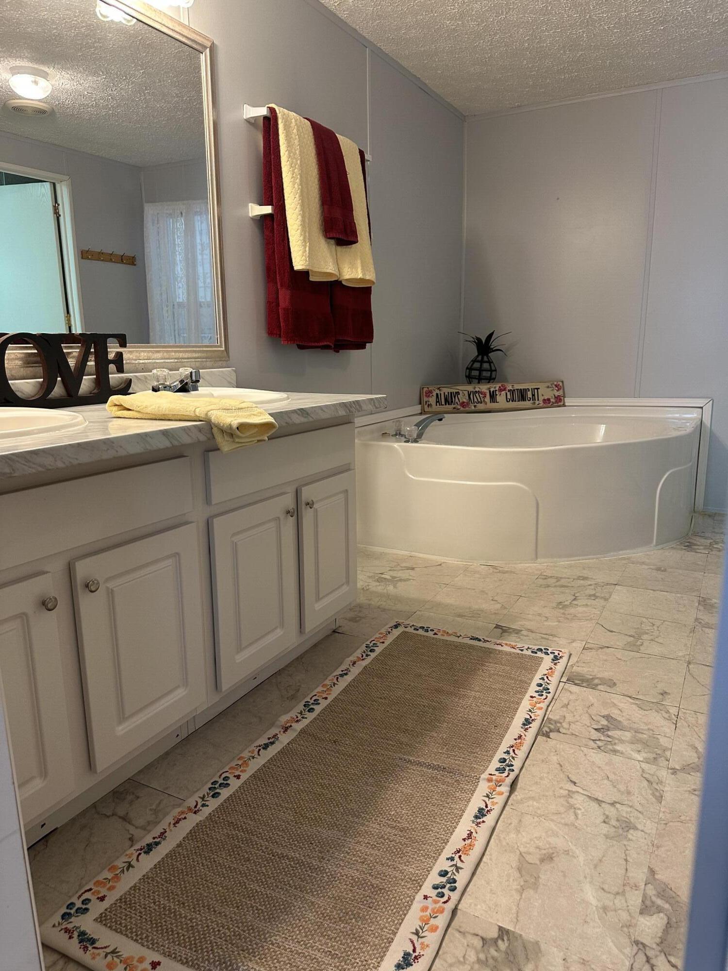 1510 Southwest 35th Circle Okeechobee, FL 34974 - Photo 26 of 53 a bathroom with a sink a mirror and a bathtub