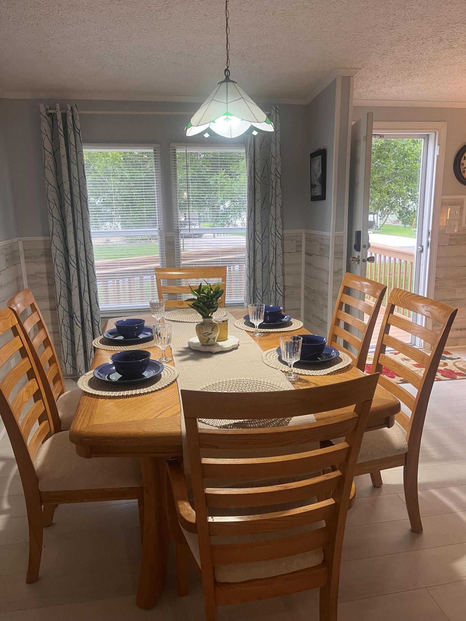 1510 Southwest 35th Circle Okeechobee, FL 34974 - Photo 6 of 53 a dining room with furniture a chandelier and wooden floor