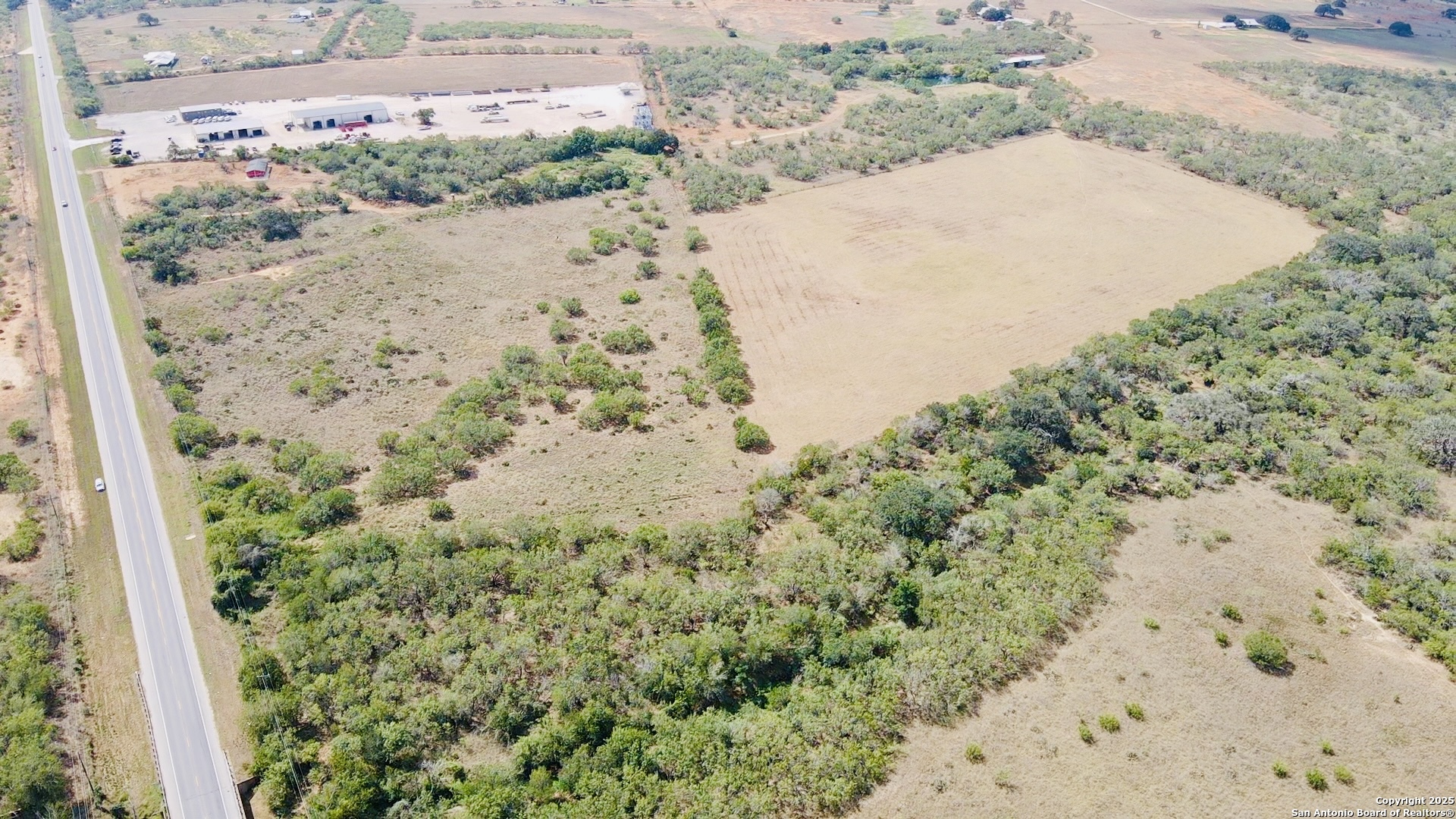 0 North State Highway 16 Jourdanton, TX 78026 - Photo 21 of 21 a view of a dry yard with trees