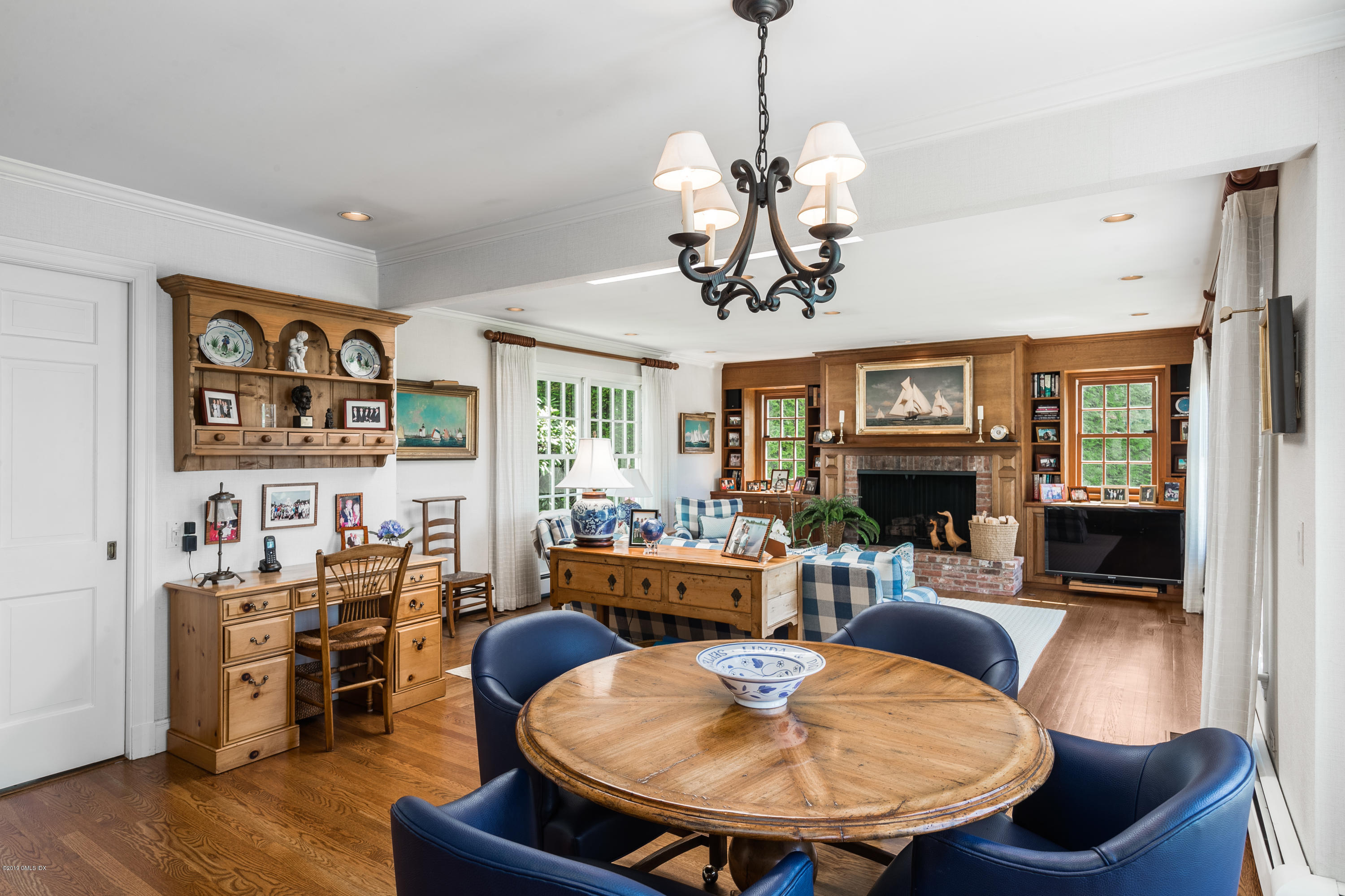 78-80 Cedar Cliff Road Riverside, CT 06878 - Photo 11 of 24 a living room with furniture a fireplace and a chandelier