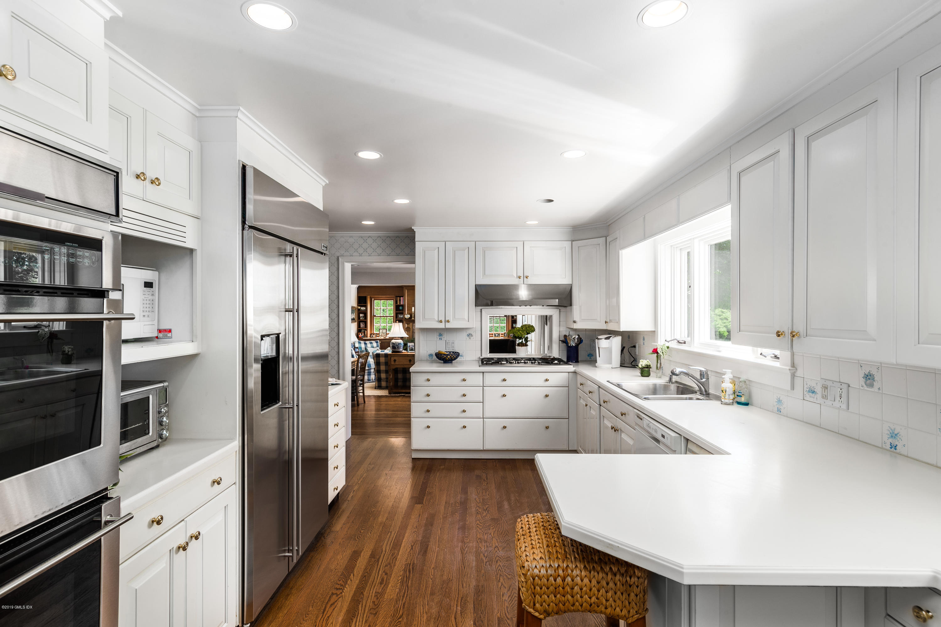 78-80 Cedar Cliff Road Riverside, CT 06878 - Photo 10 of 24 a large kitchen with stainless steel appliances lots of counter space and wooden floors