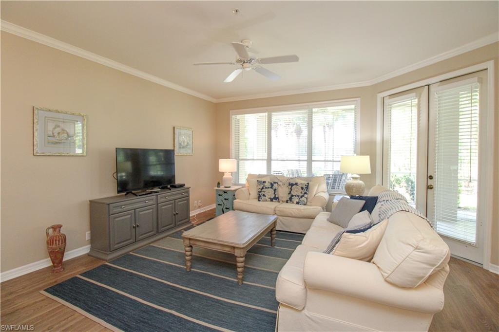 8488 Radcliffe Terrace, Unit 104 Naples, FL 34120 - Photo 16 of 50 a living room with furniture and a flat screen tv