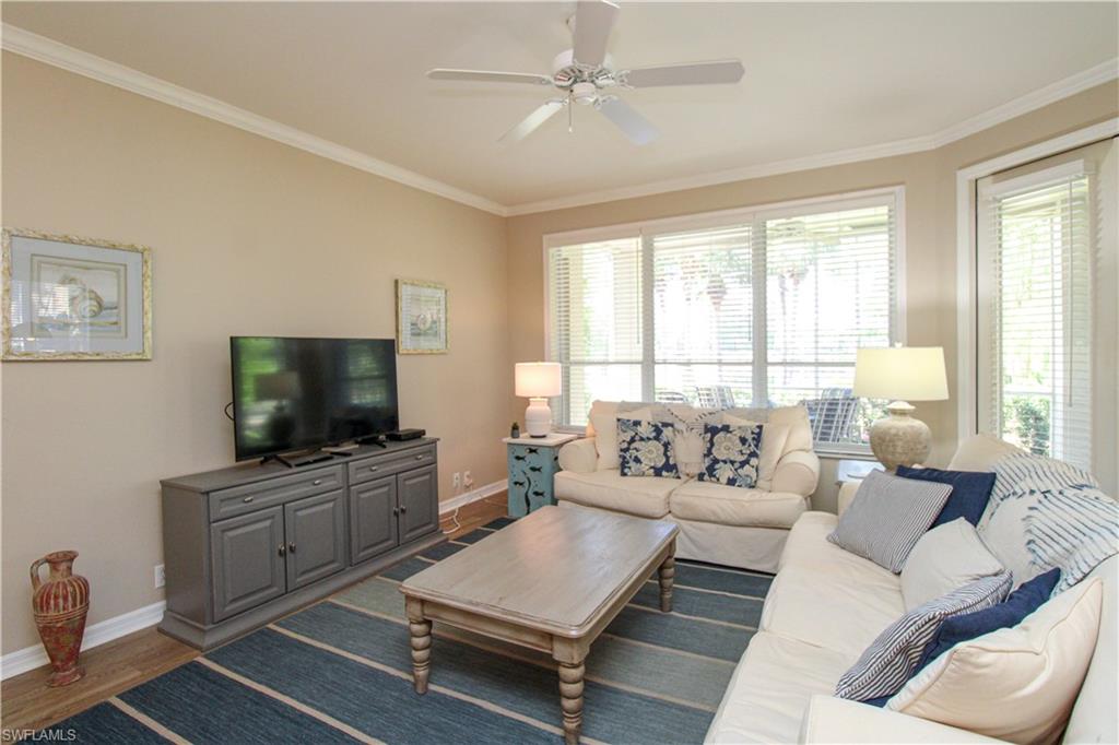 8488 Radcliffe Terrace, Unit 104 Naples, FL 34120 - Photo 17 of 50 a living room with furniture and a flat screen tv