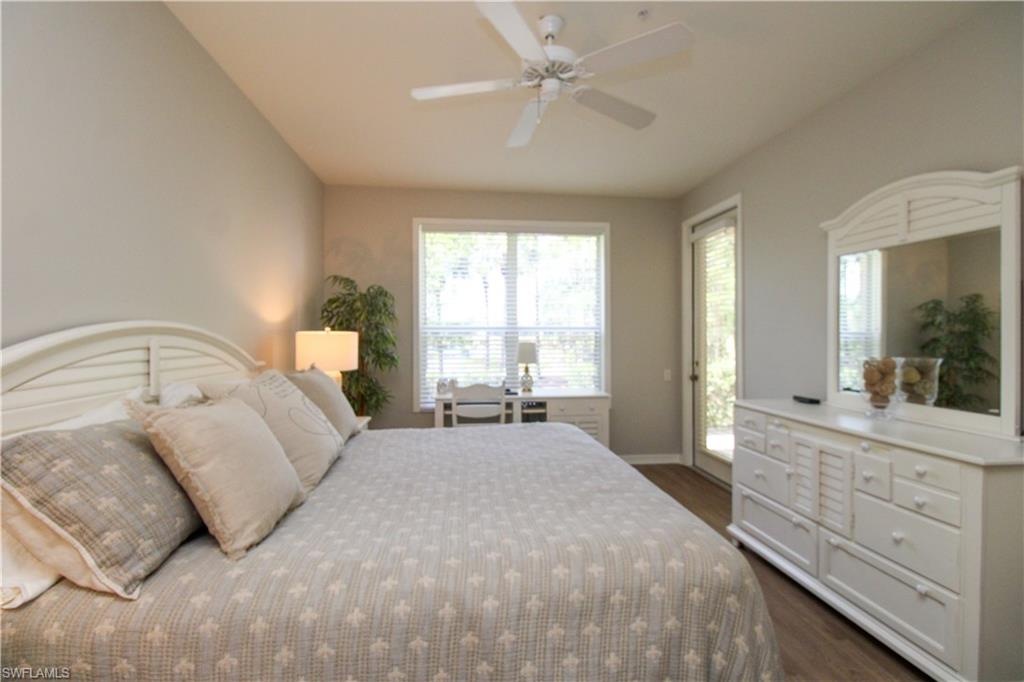8488 Radcliffe Terrace, Unit 104 Naples, FL 34120 - Photo 23 of 50 a spacious bedroom with a large bed and a large window