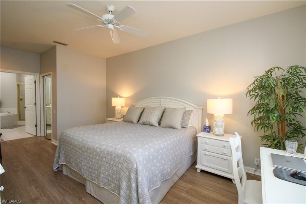 8488 Radcliffe Terrace, Unit 104 Naples, FL 34120 - Photo 24 of 50 a bedroom with a bed and a potted plant