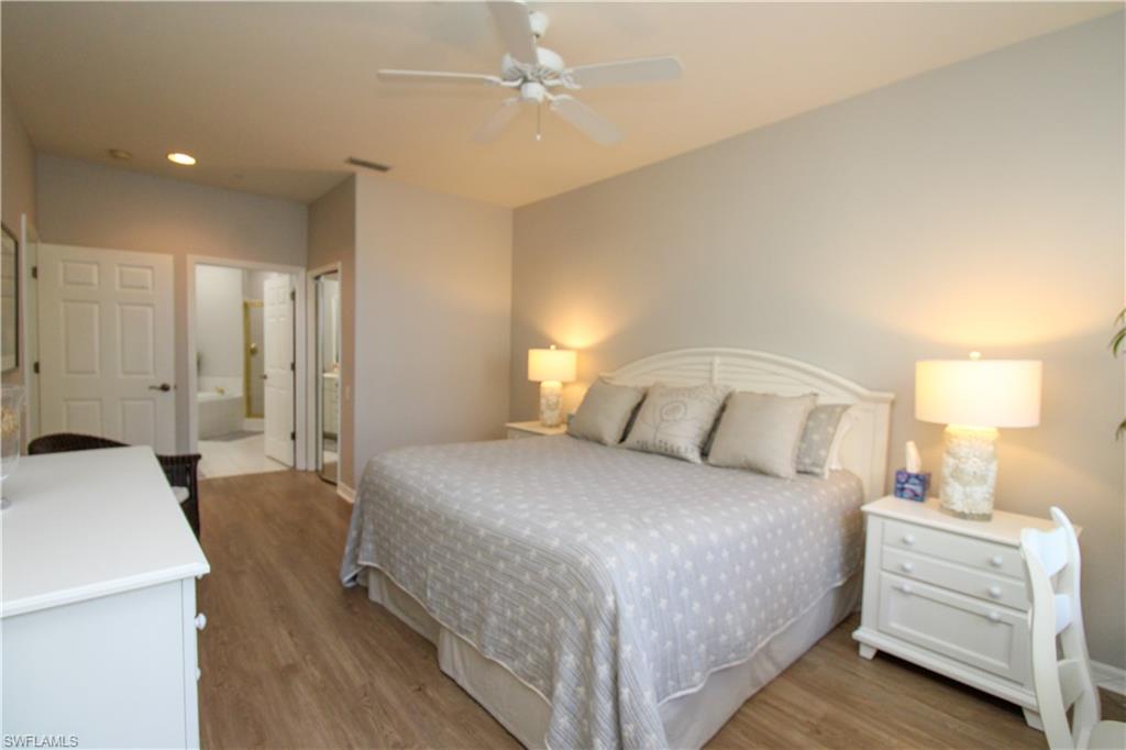 8488 Radcliffe Terrace, Unit 104 Naples, FL 34120 - Photo 26 of 50 a bedroom with a bed and a dresser