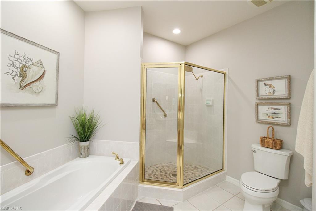 8488 Radcliffe Terrace, Unit 104 Naples, FL 34120 - Photo 30 of 50 a bathroom with a shower a toilet and a sink