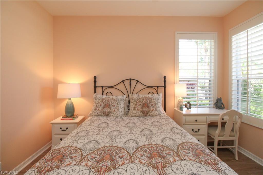 8488 Radcliffe Terrace, Unit 104 Naples, FL 34120 - Photo 33 of 50 a bedroom with a large bed and a window